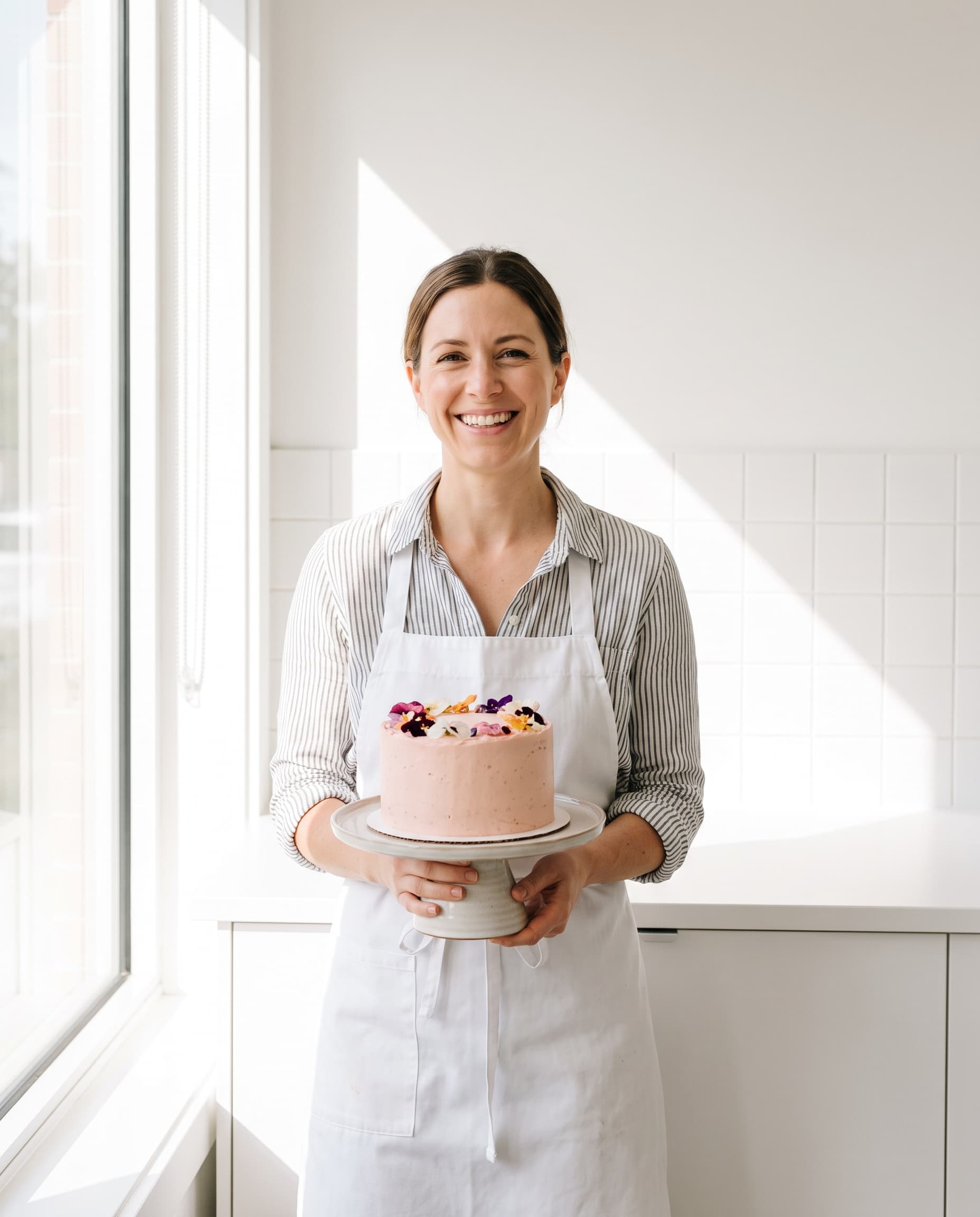 Portrait of pastry chef Klara holding a cake
